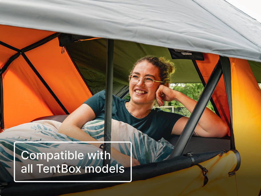 Person leaning against the BackRest inside a TentBox with text 'Compatible with all TentBox models'.