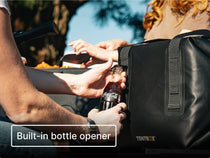 Person opening a Coca-Cola bottle using the built-in bottle opener on the side of the TentBox CoolBag.