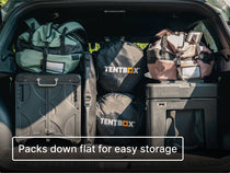 Car boot packed neatly with luggage, TentBox sleeping bags, KitchenBox and the TentBox CoolBag with text 'Packs down flat for easy storage'.